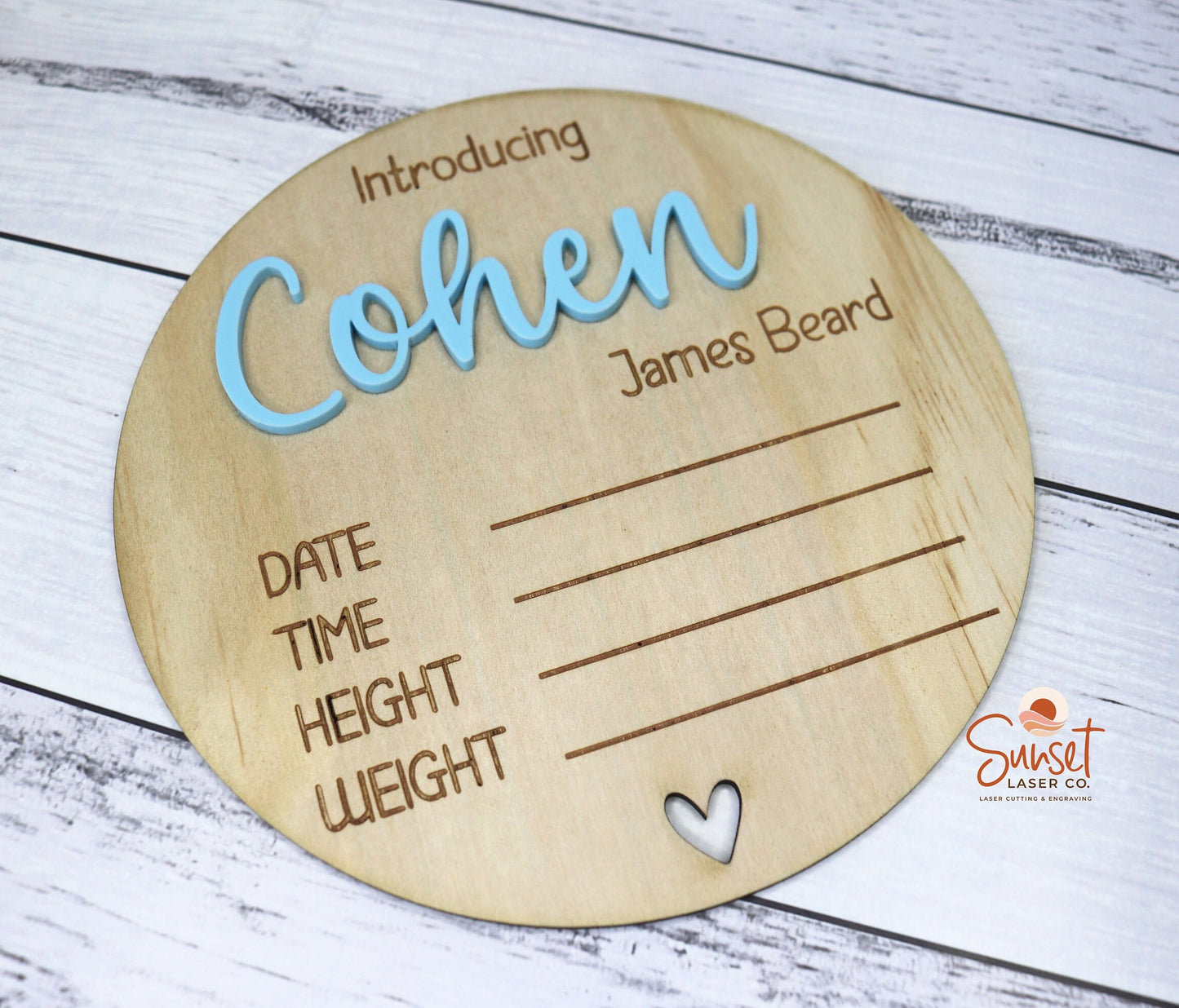 Close-up of engraved baby name on wooden plaque