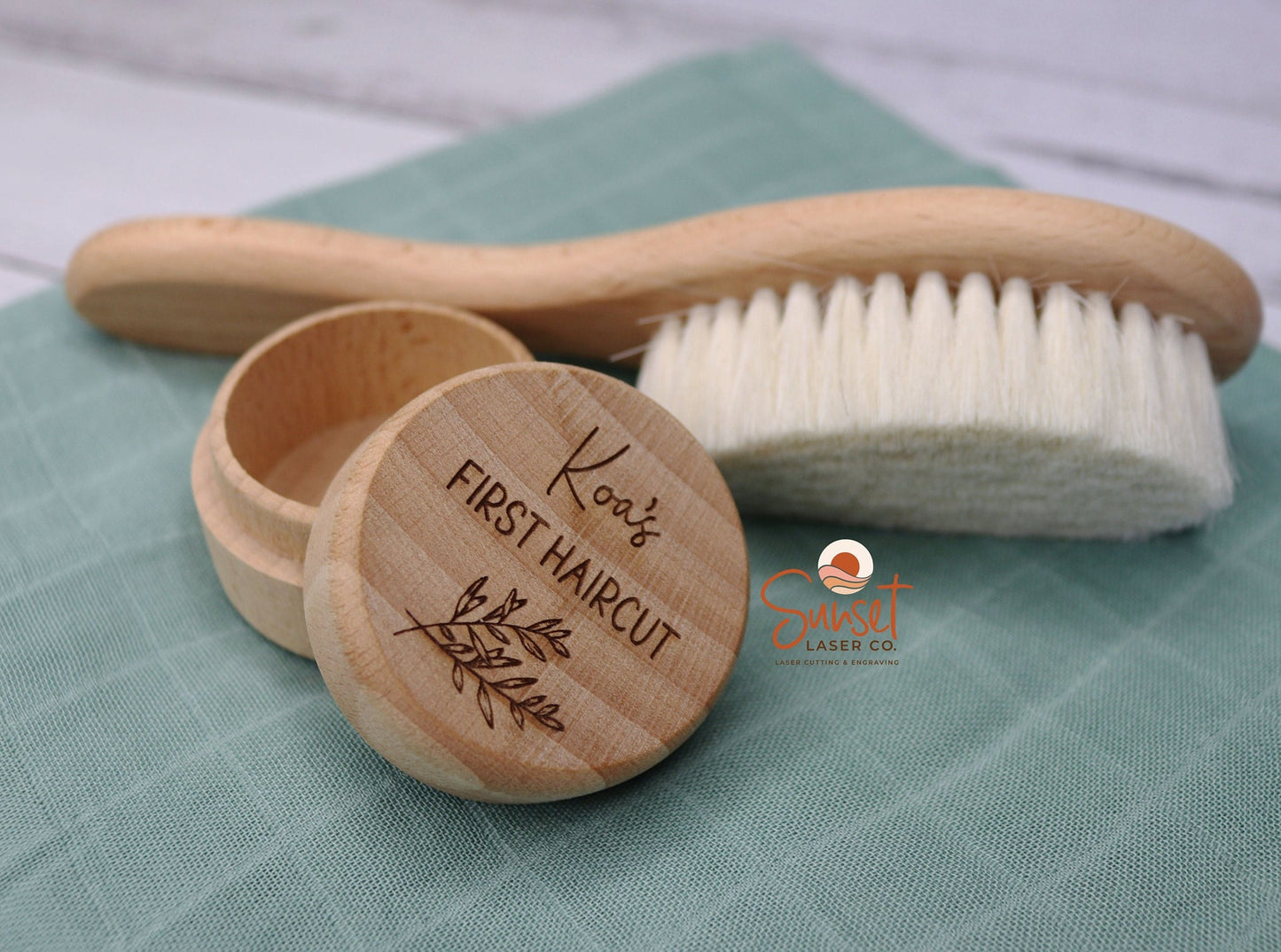 Wooden baby hair keepsake box with lid open and baby brush in the background