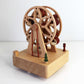 Corner View of Personalised Wooden Musical Carousel in Ferris Wheel Design with Pulley System and Mini Carriages and trees