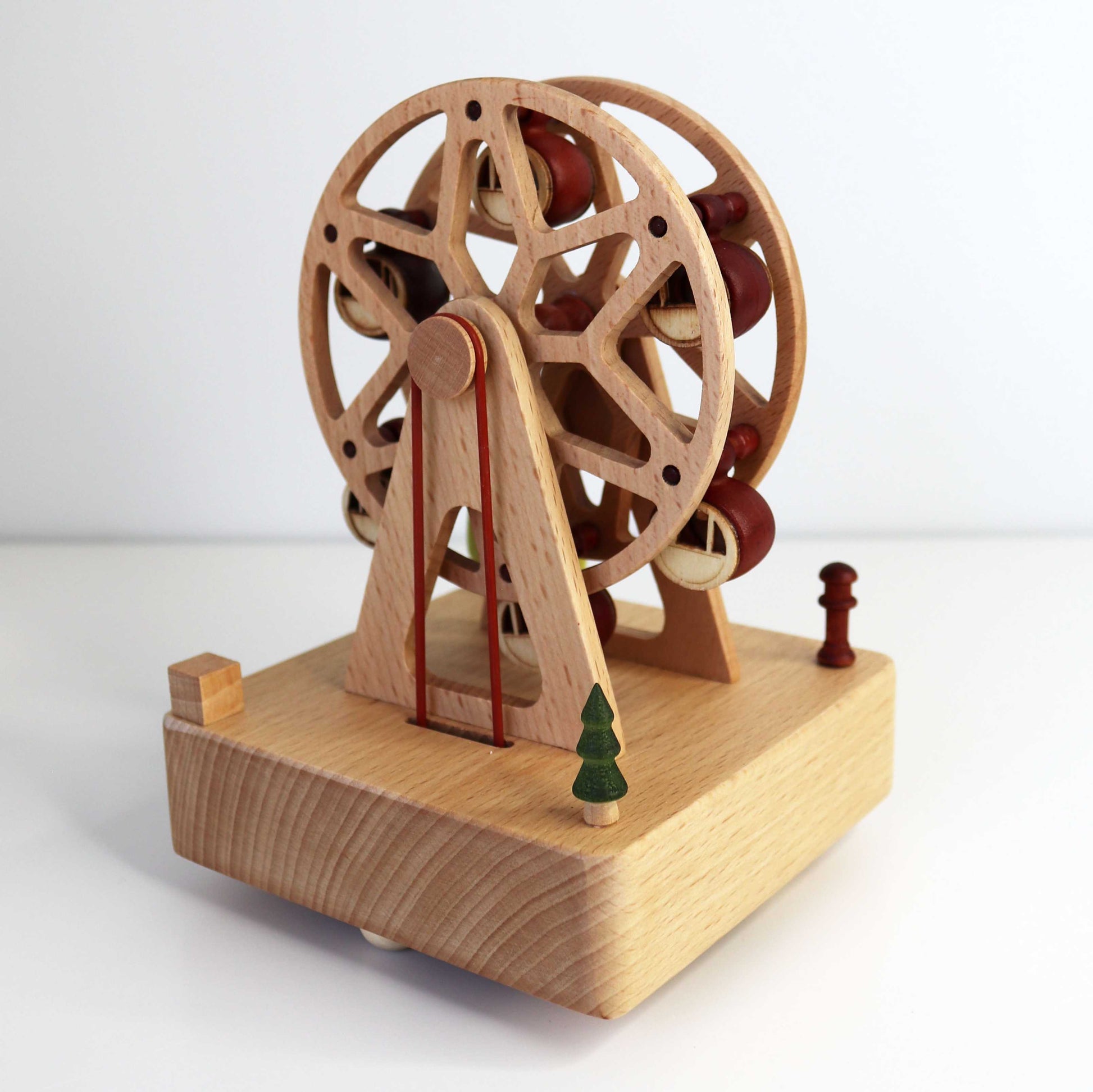 Corner View of Personalised Wooden Musical Carousel in Ferris Wheel Design with Pulley System and Mini Carriages and trees