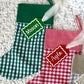Green Gingham Christmas Stocking with Green Solid Colour Cuff shown with Green and White Custom Name Tag