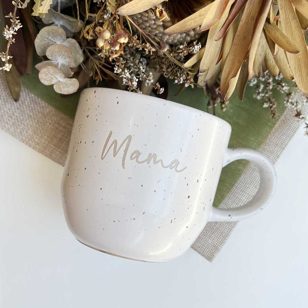 Side view of speckled ceramic mug with laser engraving