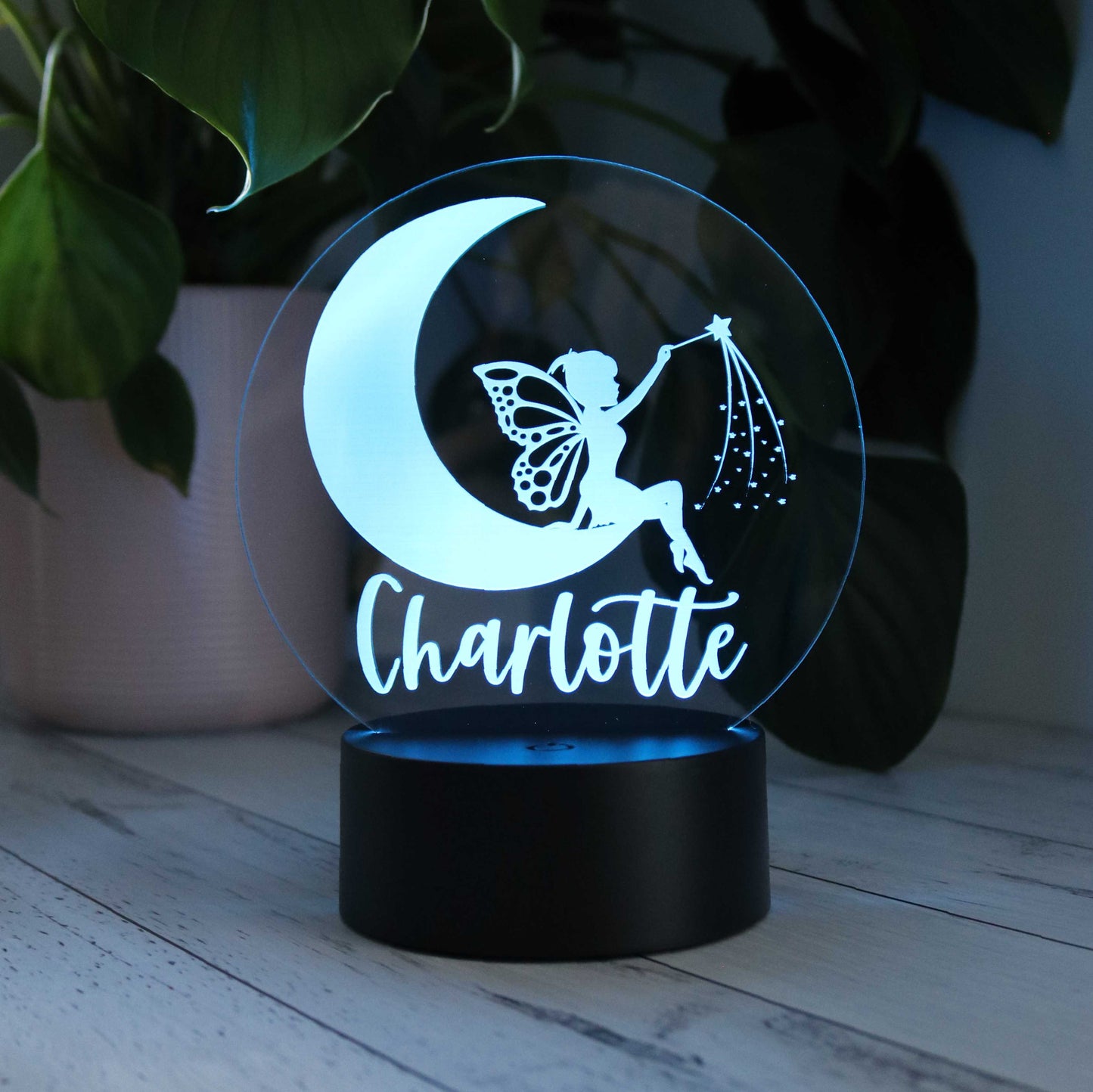 Personalised kids night light with fair moon design and customised with kids name Charlotte shown with blue LED light illuminated