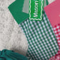 Green Gingham Christmas Stocking with Green Solid Colour Cuff shown with Green and White Custom Name Tag Video