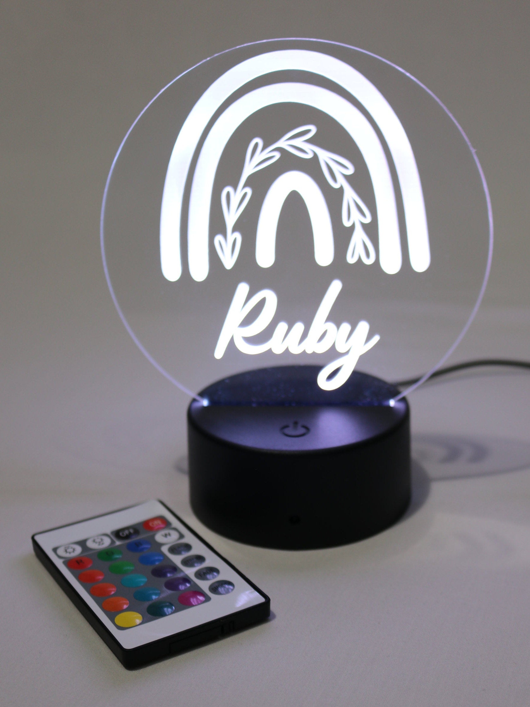 Personalised night light showing laser engraved name on a acrylic light base with remote control